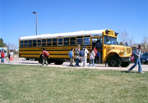 Students getting on a bus. Students getting on a bus.